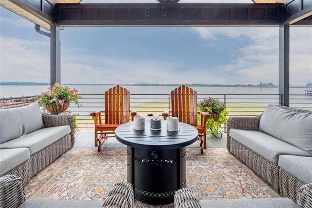 view of patio / terrace featuring a balcony, a water view, and an outdoor hangout area