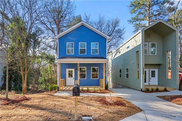 view of front of property featuring a porch, driveway, and a carport