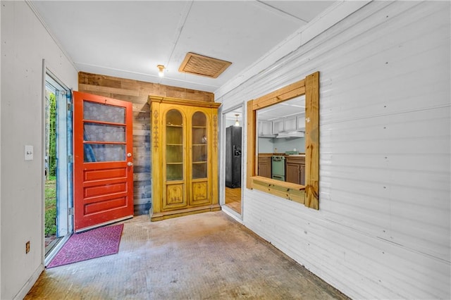 entrance foyer featuring wooden walls