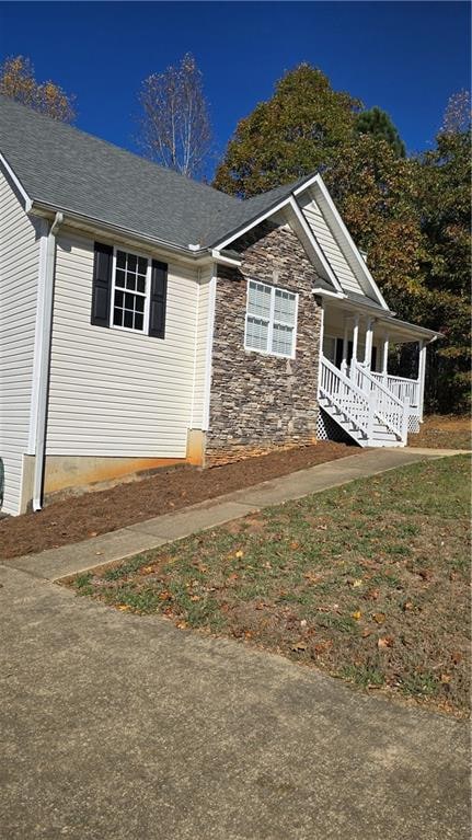 view of property exterior with a porch