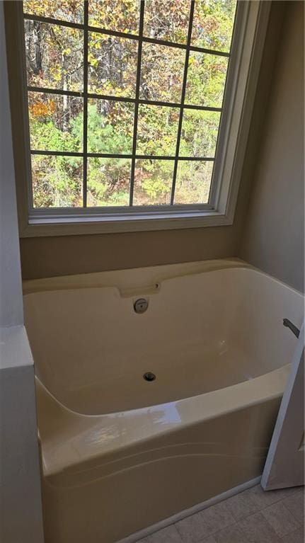 bathroom with a tub to relax in