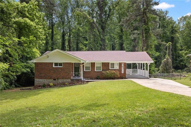 single story home featuring brick siding, fence, an attached carport, driveway, and a front yard