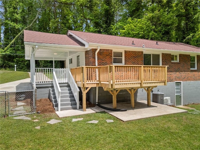 back of house with fence, cooling unit, roof with shingles, a lawn, and brick siding