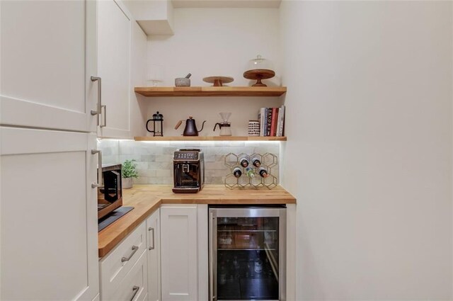 1038 Huntcliff, Atlanta, GA 30350 - bar with a dry bar, decorative backsplash, stainless steel microwave, and beverage cooler
