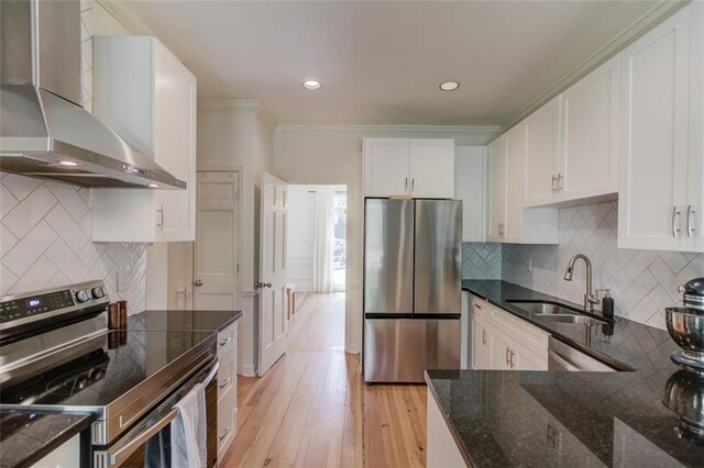 1038 Huntcliff, Atlanta, GA 30350 - kitchen featuring wall chimney range hood, white cabinets, a sink, and appliances with stainless steel finishes