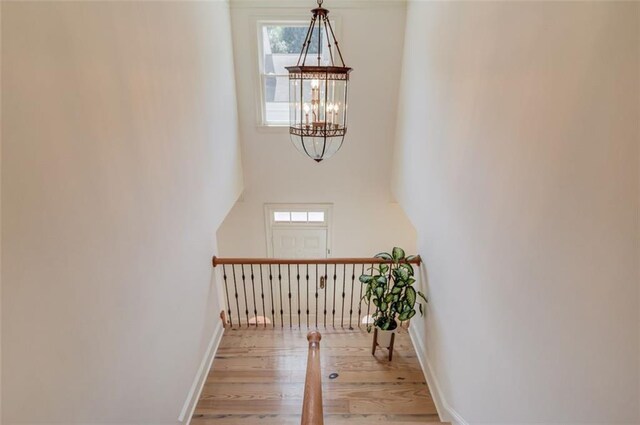 1038 Huntcliff, Atlanta, GA 30350 - interior space with a chandelier, wood finished floors, baseboards, and a high ceiling