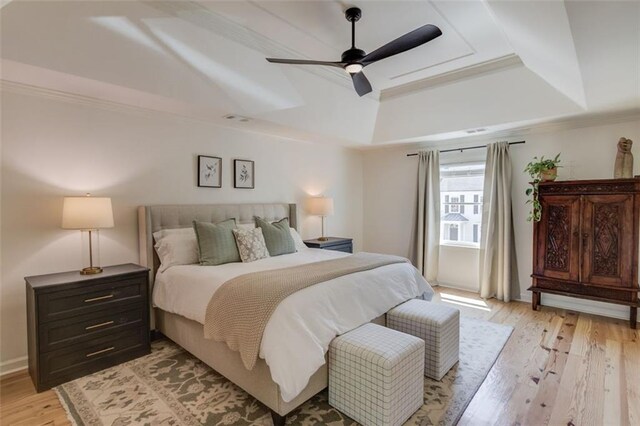 1038 Huntcliff, Atlanta, GA 30350 - bedroom with baseboards, ceiling fan, crown molding, a tray ceiling, and light wood-style flooring