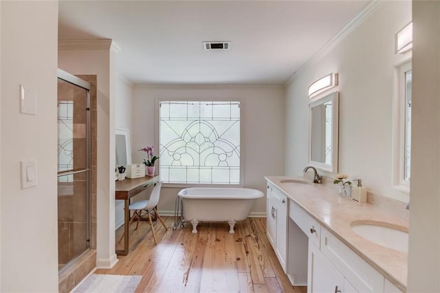 1038 Huntcliff, Atlanta, GA 30350 - bathroom featuring visible vents, a sink, a soaking tub, a shower stall, and wood-type flooring
