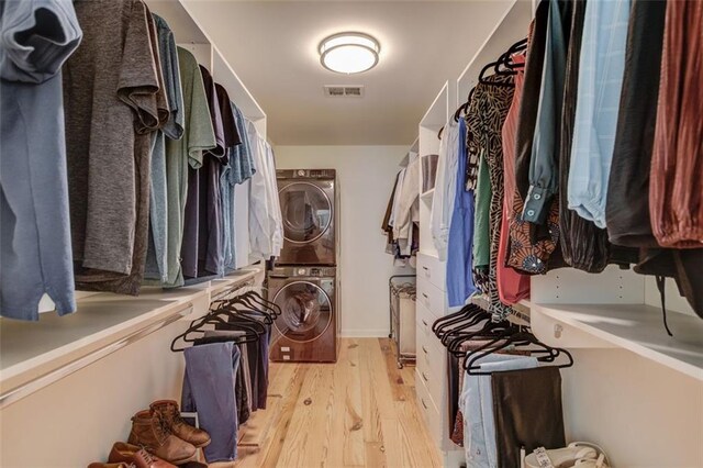 1038 Huntcliff, Atlanta, GA 30350 - walk in closet with light wood-type flooring, visible vents, and stacked washer and dryer