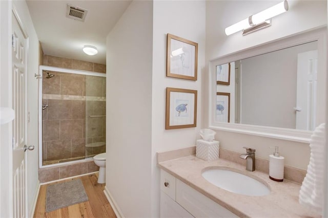 1038 Huntcliff, Atlanta, GA 30350 - bathroom featuring a shower stall, wood finished floors, vanity, and visible vents