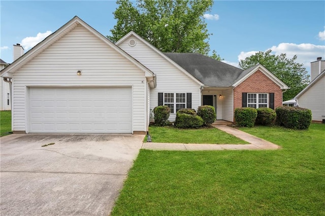 view of front facade with concrete driveway, a front yard, an attached garage, and brick siding