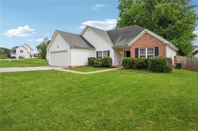 single story home featuring fence, concrete driveway, a front yard, and brick siding
