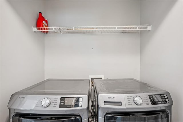 laundry room with separate washer and dryer and laundry area