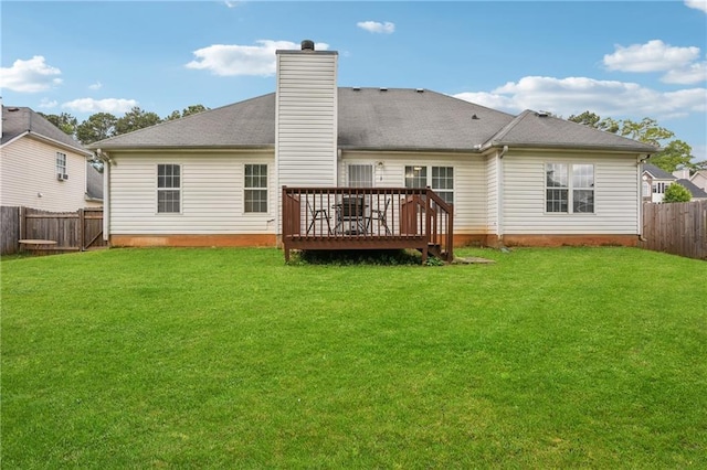 back of property featuring a deck, a chimney, a fenced backyard, and a yard