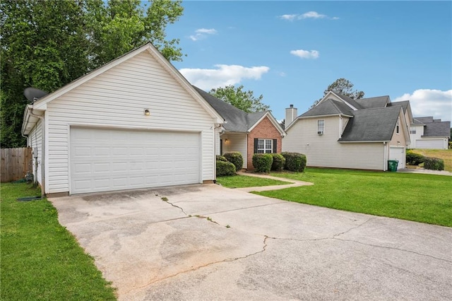 ranch-style house with driveway, an attached garage, and a front lawn