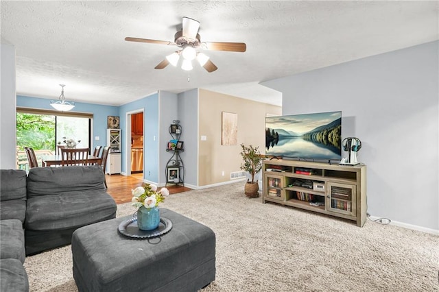 150 Victoria Sta, Woodstock, GA 30189 - carpeted living area with a ceiling fan, baseboards, and a textured ceiling
