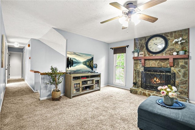 150 Victoria Sta, Woodstock, GA 30189 - living room with a textured ceiling, carpet flooring, ceiling fan, a stone fireplace, and baseboards