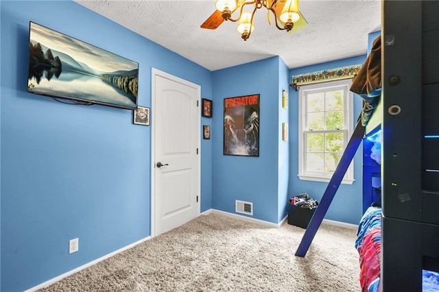 150 Victoria Sta, Woodstock, GA 30189 - carpeted bedroom with baseboards, a textured ceiling, a chandelier, and ceiling fan