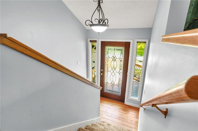 150 Victoria Sta, Woodstock, GA 30189 - foyer featuring stairway, vaulted ceiling, wood-type flooring, and baseboards