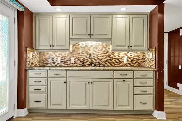150 Victoria Sta, Woodstock, GA 30189 - kitchen with a sink, cream cabinetry, backsplash, light wood-type flooring, and recessed lighting