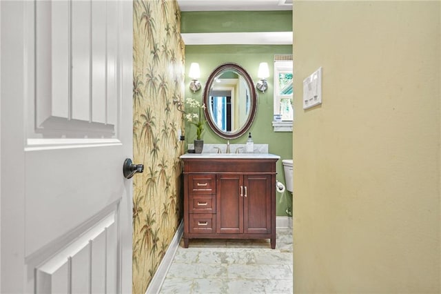 150 Victoria Sta, Woodstock, GA 30189 - half bath featuring baseboards, vanity, marble look tile flooring, wallpapered walls, and toilet