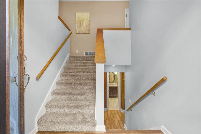 150 Victoria Sta, Woodstock, GA 30189 - staircase with wood finished floors and baseboards