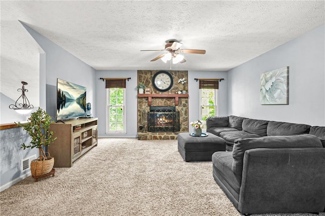 150 Victoria Sta, Woodstock, GA 30189 - carpeted living area featuring a ceiling fan, a fireplace, a textured ceiling, and baseboards