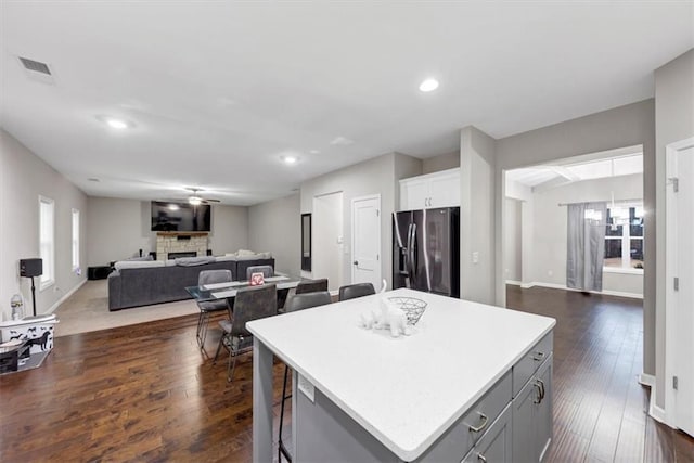 kitchen with gray cabinets, white cabinetry, a center island, ceiling fan, and stainless steel fridge with ice dispenser