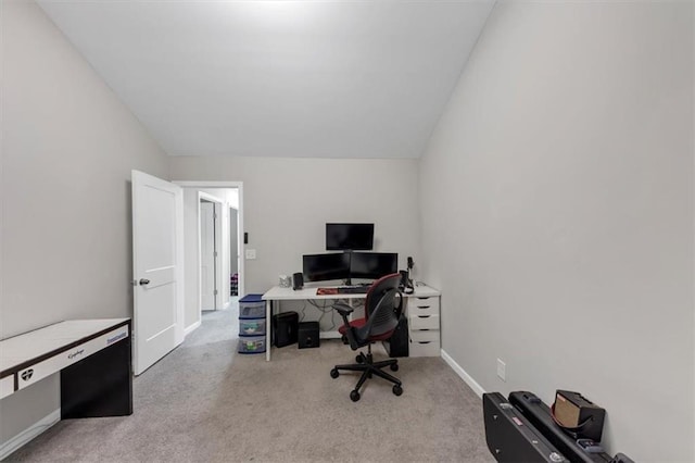 office with light colored carpet and lofted ceiling