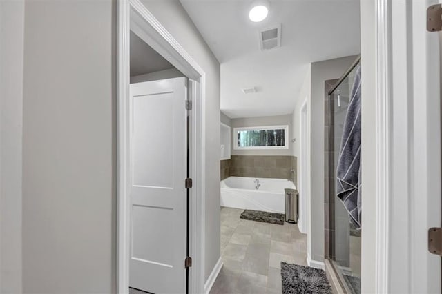 bathroom featuring independent shower and bath