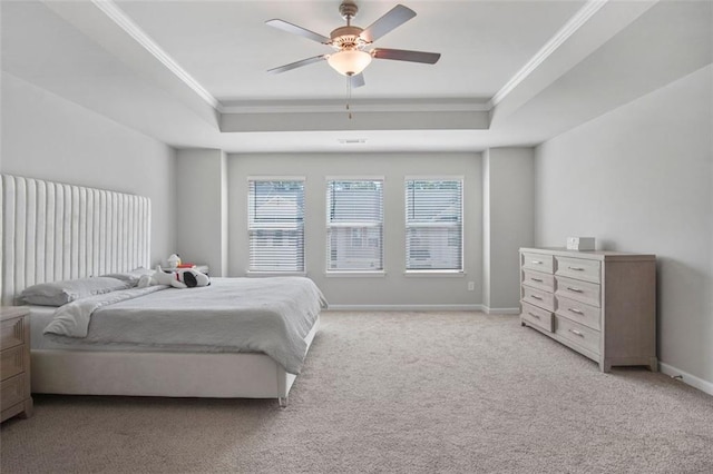 bedroom featuring crown molding, light colored carpet, a raised ceiling, and ceiling fan