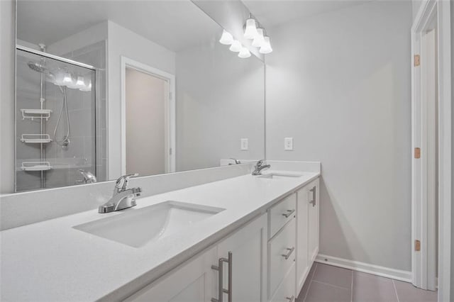 bathroom featuring tile patterned floors, a shower with shower door, and vanity