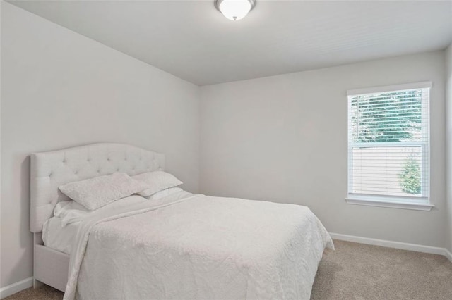 bedroom featuring light colored carpet