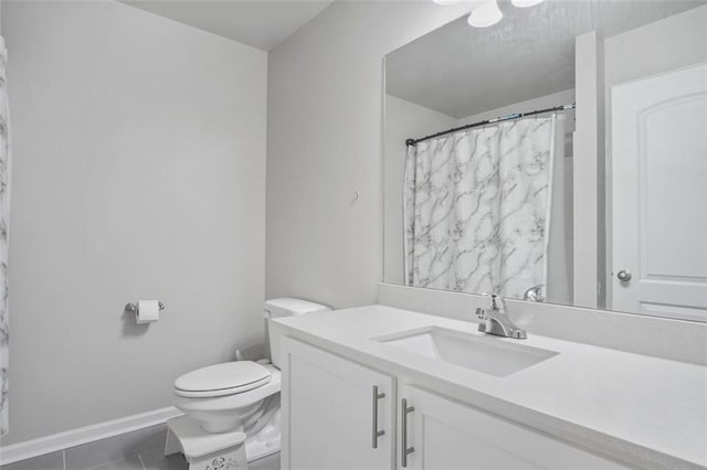 bathroom with tile patterned flooring, vanity, and toilet