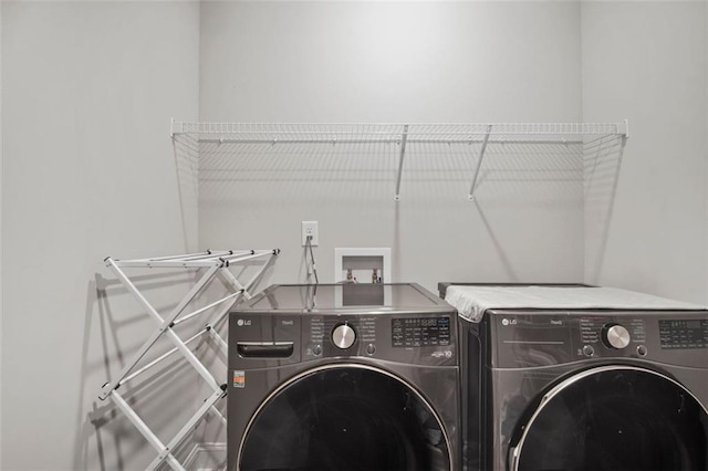 washroom with independent washer and dryer