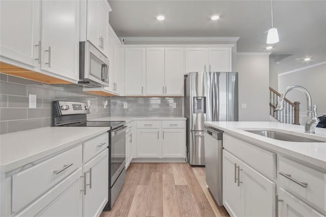 kitchen with white cabinetry, appliances with stainless steel finishes, and sink