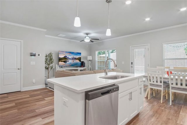 kitchen featuring sink, white cabinetry, hanging light fixtures, dishwasher, and a kitchen island with sink