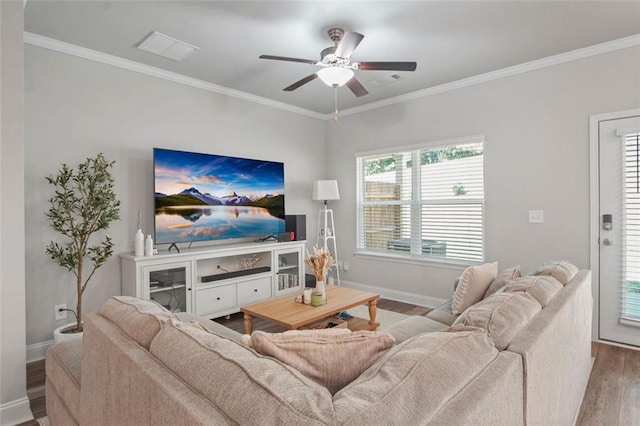 living room with hardwood / wood-style flooring, ceiling fan, and crown molding