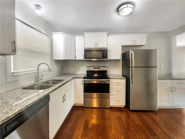 kitchen featuring sink, stainless steel appliances, white cabinets, and dark wood-type flooring