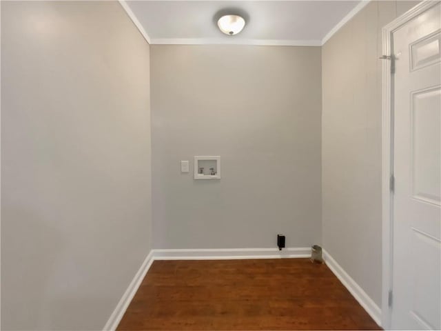 laundry area featuring washer hookup, crown molding, and dark hardwood / wood-style floors