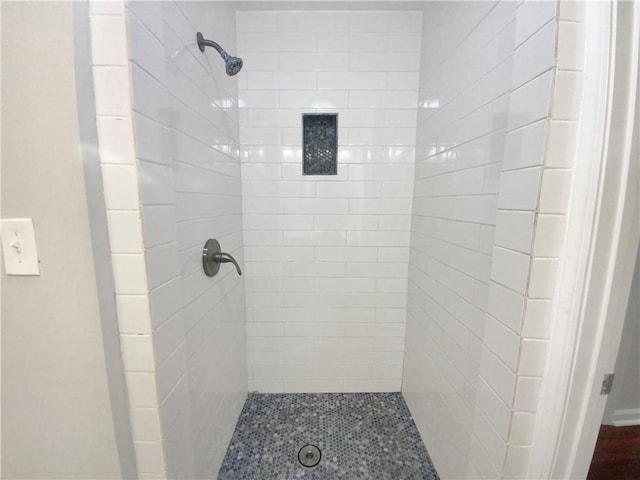 bathroom with a tile shower