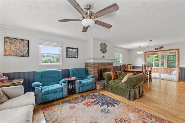 1690 Cedar Grove Dr, Marietta, GA 30066 - living area with a textured ceiling, wood finished floors, ceiling fan, and a fireplace