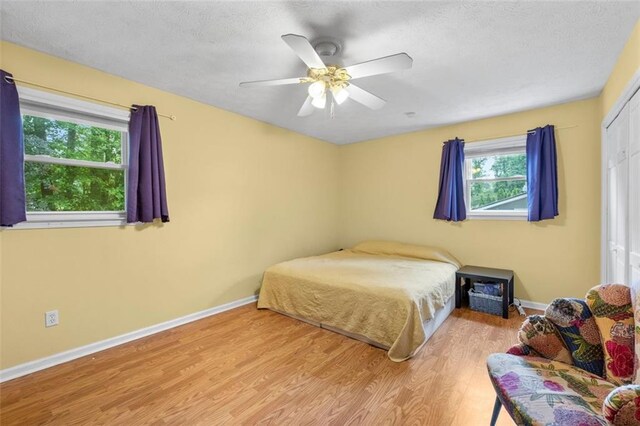 1690 Cedar Grove Dr, Marietta, GA 30066 - bedroom with wood finished floors, baseboards, a ceiling fan, and a textured ceiling