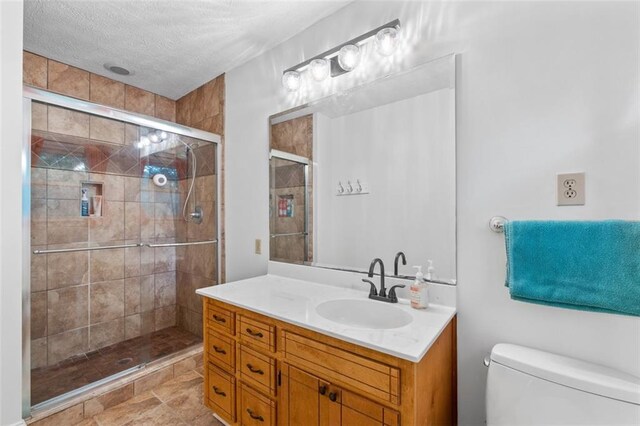 1690 Cedar Grove Dr, Marietta, GA 30066 - full bath with vanity, toilet, a stall shower, and a textured ceiling
