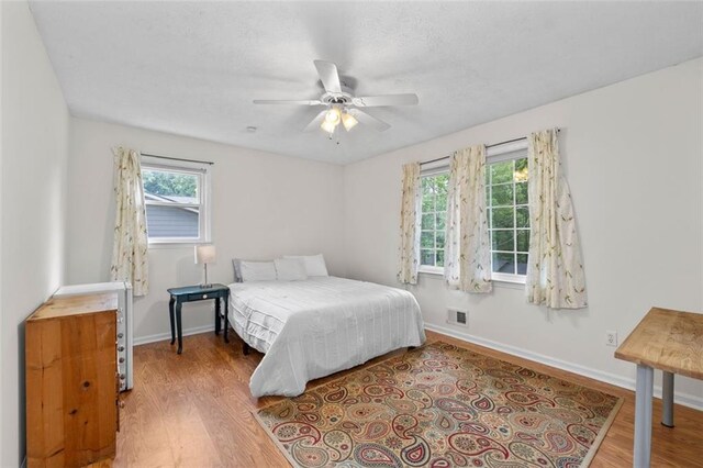 1690 Cedar Grove Dr, Marietta, GA 30066 - bedroom featuring wood finished floors, baseboards, and a ceiling fan