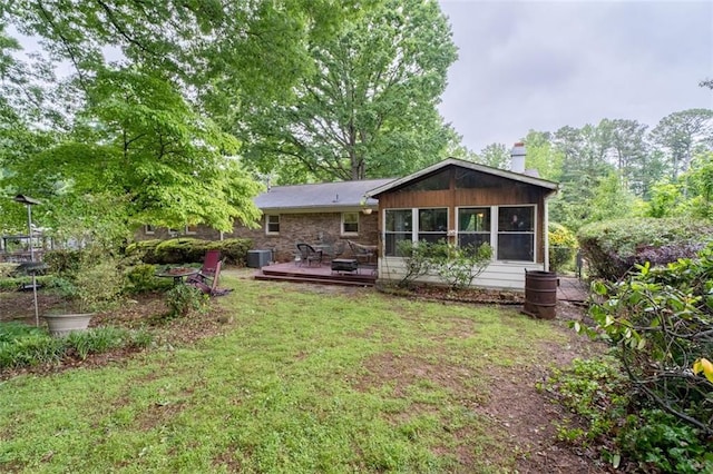 1690 Cedar Grove Dr, Marietta, GA 30066 - back of property with a wooden deck, a chimney, central AC unit, and a lawn