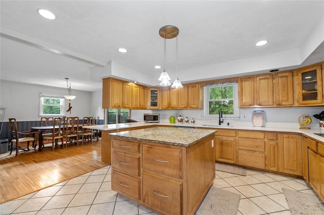 1690 Cedar Grove Dr, Marietta, GA 30066 - kitchen with stainless steel microwave, a sink, a kitchen island, brown cabinets, and recessed lighting