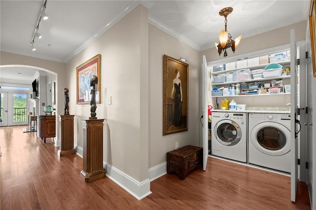3330 Overland Dr, Roswell, GA 30075 - washroom featuring arched walkways, separate washer and dryer, wood finished floors, a chandelier, and crown molding