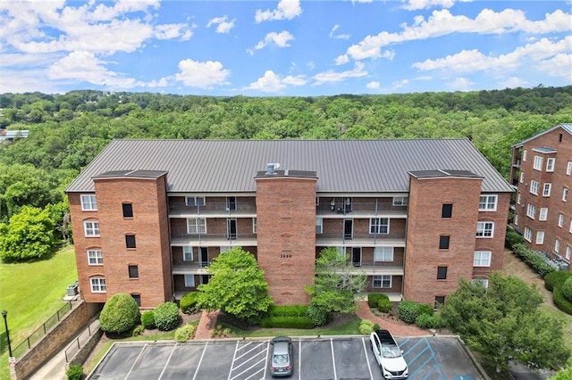 3330 Overland Dr, Roswell, GA 30075 - view of building exterior featuring uncovered parking and a view of trees