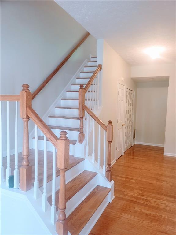 523 Lantern Wood Dr, Scottdale, GA 30079 - stairway with baseboards and wood finished floors